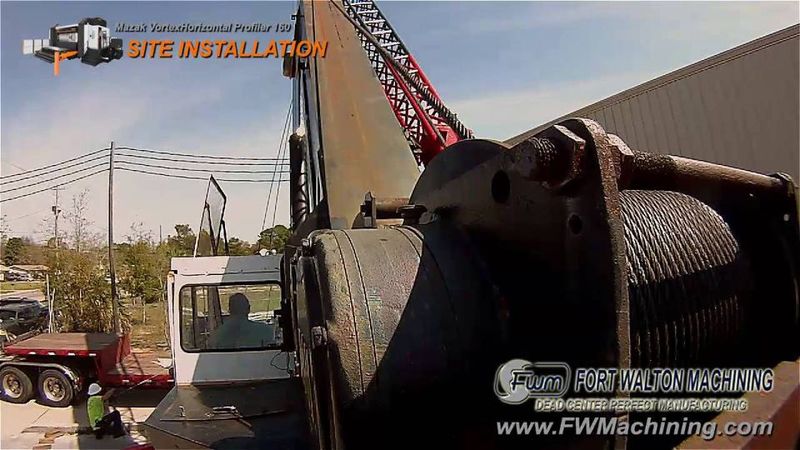 Crane lifting a Mazak horizontal profiler during installation